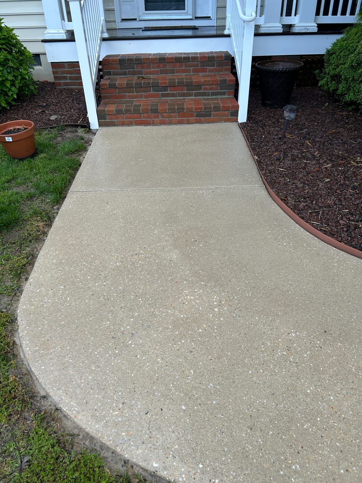 Restored concrete walkway after professional surface cleaning in Delaware