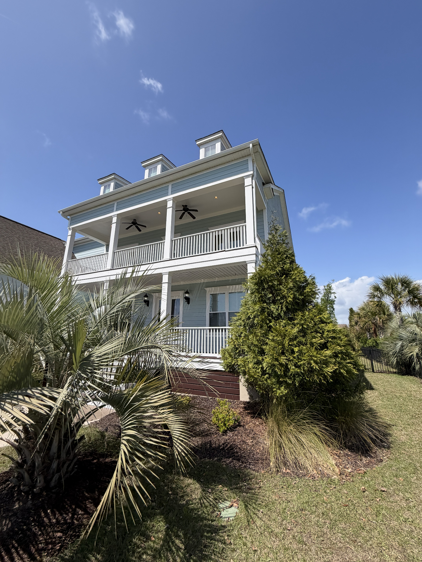 Blue two-story home side view after professional soft wash in Delaware